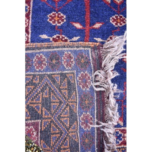 613 - A Persian Bokhara rug, gul design on brick ground, multi borders, 105 cm x 51 cm, to/w two Baluch na... 