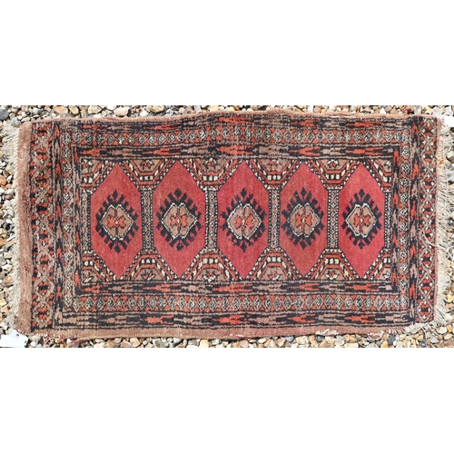 614 - A Turkish geometric design red ground rug, 120 cm x 71 cm, to/w a machine made Kashan style rug and ... 