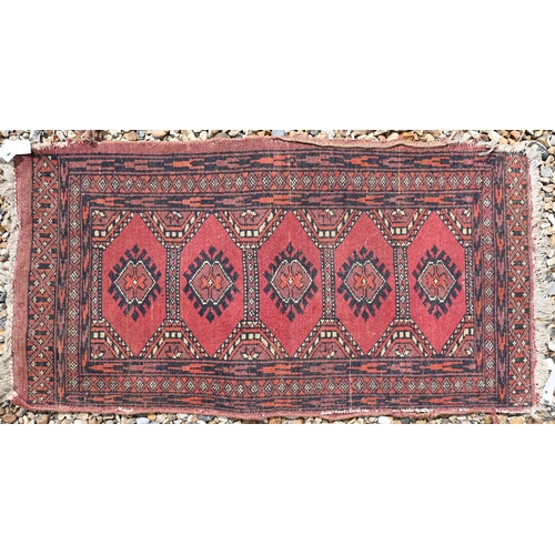 614 - A Turkish geometric design red ground rug, 120 cm x 71 cm, to/w a machine made Kashan style rug and ... 