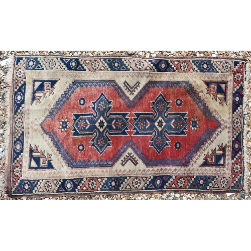 614 - A Turkish geometric design red ground rug, 120 cm x 71 cm, to/w a machine made Kashan style rug and ... 