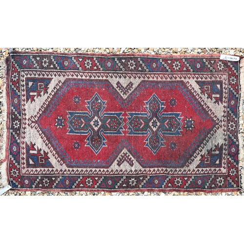 614 - A Turkish geometric design red ground rug, 120 cm x 71 cm, to/w a machine made Kashan style rug and ... 