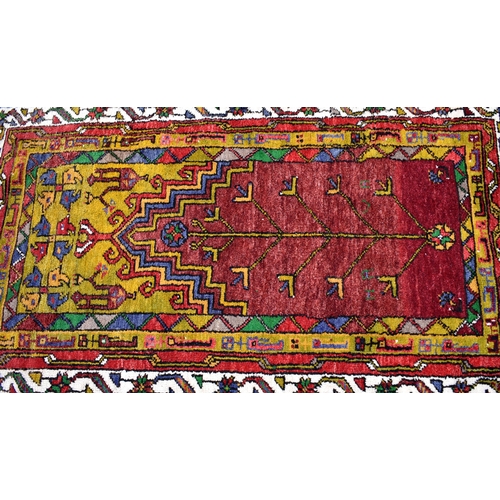 620 - Turkish kelim-ended red and lime green rug with stylised design, 200 x 125 cm