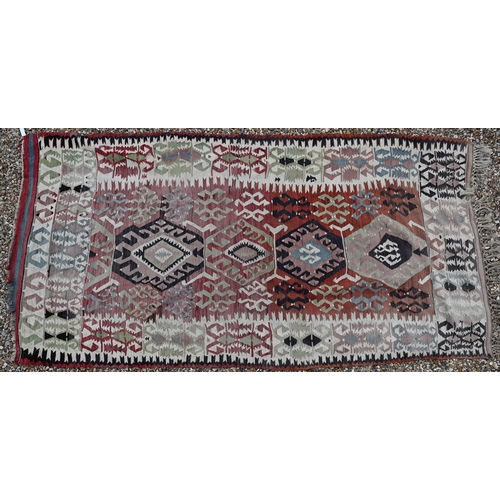 622 - Kelim, geometric designs on abrashed red ground with ivory border, 285 x 144 cm