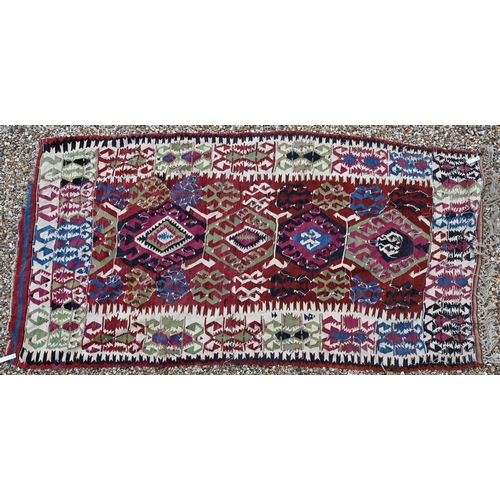 622 - Kelim, geometric designs on abrashed red ground with ivory border, 285 x 144 cm