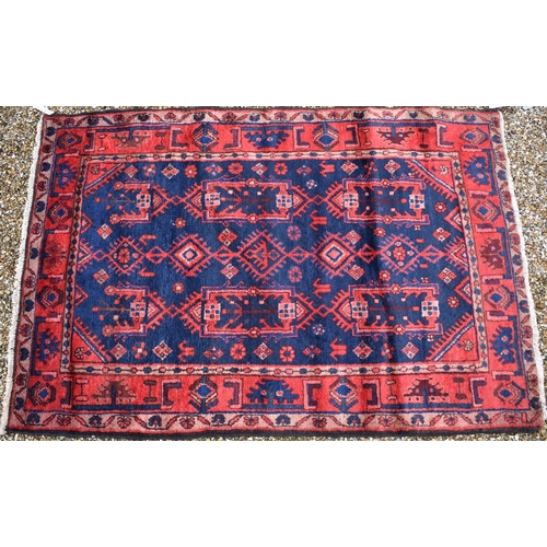 624 - Persian Hamadan navy ground rug, stylised floral design, red border, 170 x 115 cm