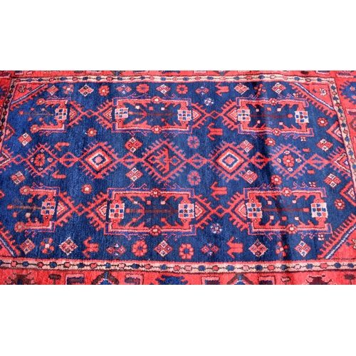 624 - Persian Hamadan navy ground rug, stylised floral design, red border, 170 x 115 cm