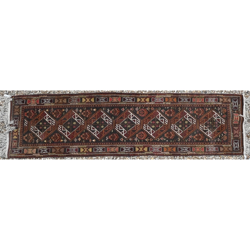 626 - A Turkish brown ground runner with geometric medallions and repeating borders, 294 x 80 cm