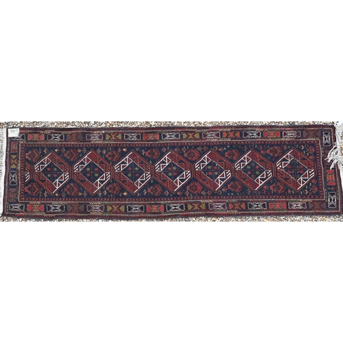 626 - A Turkish brown ground runner with geometric medallions and repeating borders, 294 x 80 cm