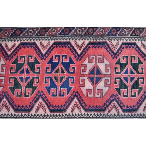 627 - A Caucasian geometric design red ground runner with brown border, 310 x 80 cm