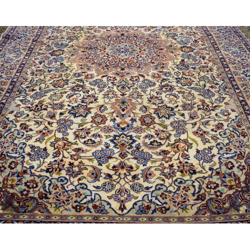 631 - A Persian Yazd carpet, with traditional floral design around large central medallion on beige ground... 