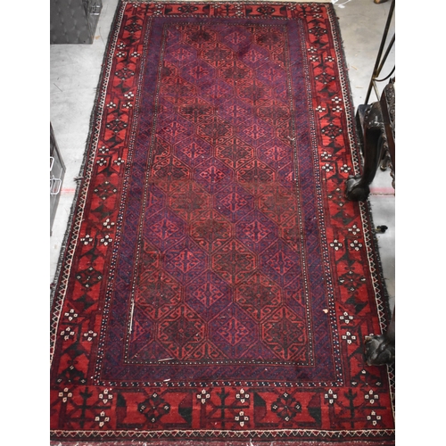 633 - A contemporary Belouch rug, the repeating geometric design on dark red ground, 190 cm x 95 cm