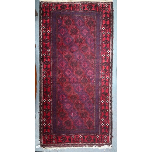 633 - A contemporary Belouch rug, the repeating geometric design on dark red ground, 190 cm x 95 cm