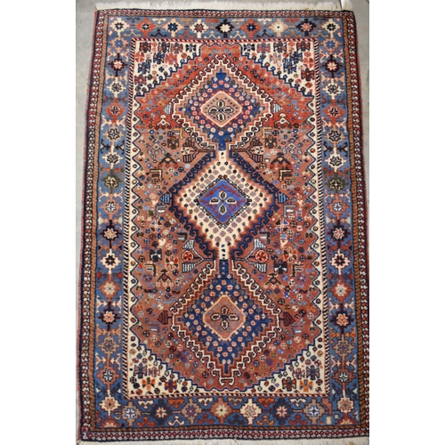 637 - Small Caucasian brick ground rug, diamond medallions, blue border, 130 x 83 cm