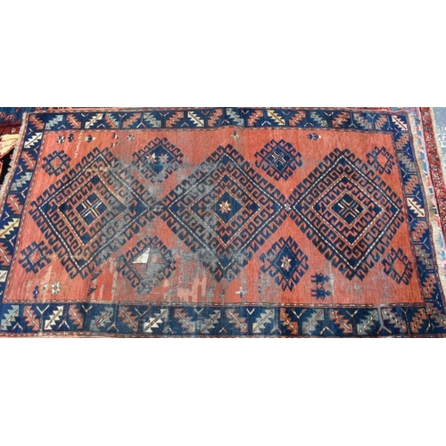 638 - A Persian Hamadan rug, the red ground with triple lozenges design, 115 cm x 198 cm