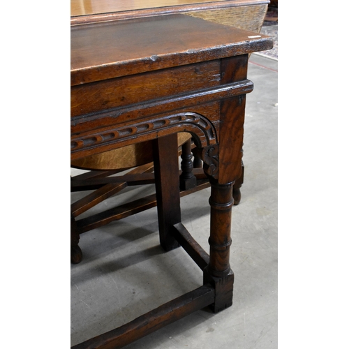 645 - An antique oak narrow console table with chip-carved frieze and turned supports united by stretchers... 