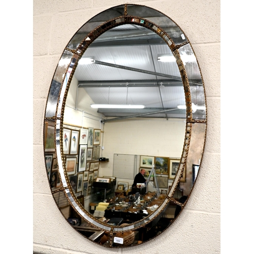 649 - Venetian style oval wall mirror with gilt floral embellished gilt metal edging, 105 x 70 cm