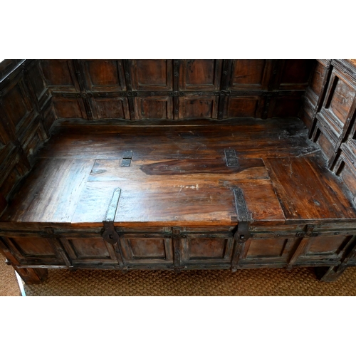 65 - An antique Indian teak box seat settle/bench, 145 cm x 80 cm x 98 cm h o/all (the seat 70 cm deep x ... 