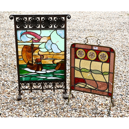 651 - An Art Deco wrought iron fire-screen with floral and scroll designs framing on stained glass galleon... 