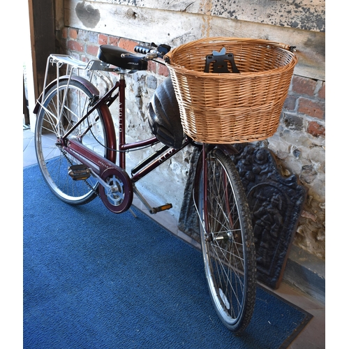 682 - An Apollo County lady's bicycle with front basket and rear pannier, c/w helmet and pump