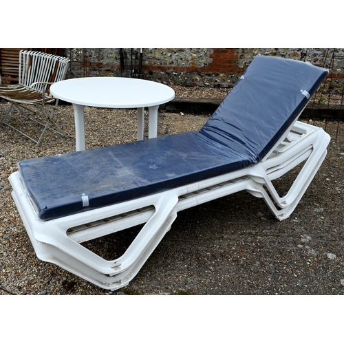 69 - A pair of Balliu polypropylene reclining sun loungers, c/w one single blue cushion, new old stock; a... 