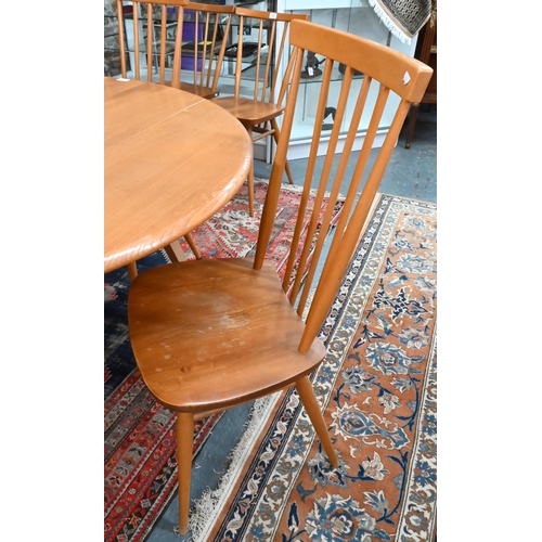 75 - A vintage Ercol drop leaf table to/with four stick back side chairs (5)