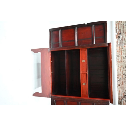 77 - An antique Chinese red lacquer Chinese cabinet with brass mounts, the pair of doors enclosing an int... 