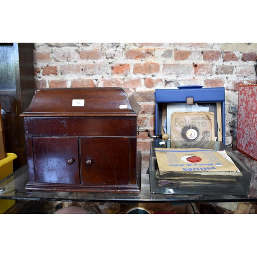 79 - A vintage oak cased HMV wind-up gramophone to/w and assortment of 78's and vinyl discs