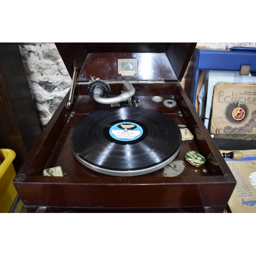 79 - A vintage oak cased HMV wind-up gramophone to/w and assortment of 78's and vinyl discs