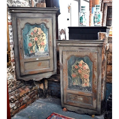 80 - A pair of 19th century continental painted pine hanging corner cabinets, the polychrome floral decor... 