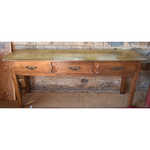 84 - An old continental French three drawer low dresser/serving table raised on square legs, 179 cm w x 4... 