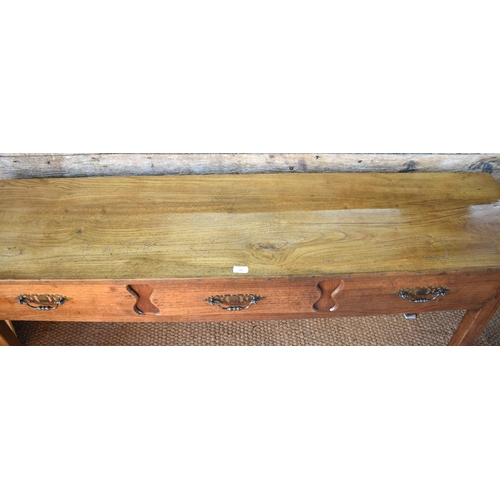 84 - An old continental French three drawer low dresser/serving table raised on square legs, 179 cm w x 4... 