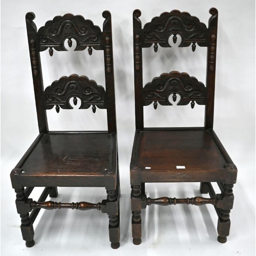 85 - A companion pair of carved oak chairs in the 17th century style, with plank seats (2)