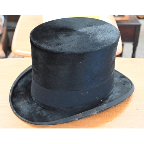 204 - Two antique leather top-hat boxes, each containing a black top hat to/w a grey 'Wedding' top hat by ... 