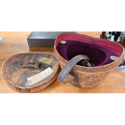 204 - Two antique leather top-hat boxes, each containing a black top hat to/w a grey 'Wedding' top hat by ... 