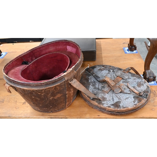 204 - Two antique leather top-hat boxes, each containing a black top hat to/w a grey 'Wedding' top hat by ... 