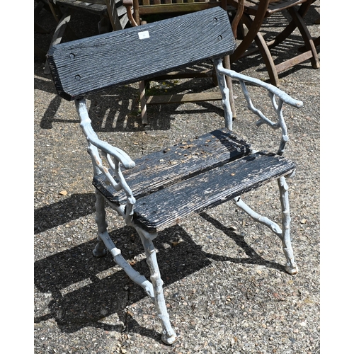 16 - A naturalistic painted cast iron garden chair with stained hardwood back and seat, 65 cm w