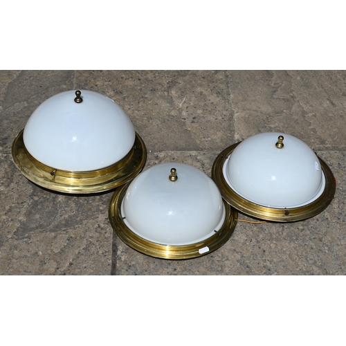22 - A pair of circular brass ceiling lights with opaque glass shades to/w somewhat similar larger exampl... 