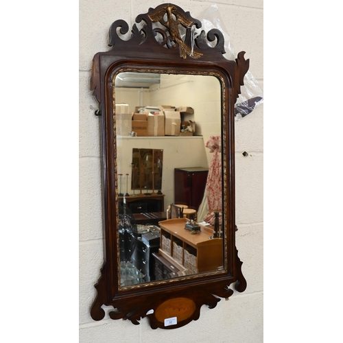 32 - A bevelled wall mirror in fret cut mahogany and shell inlaid frame surmounted by gilt ho-ho bird, a/... 