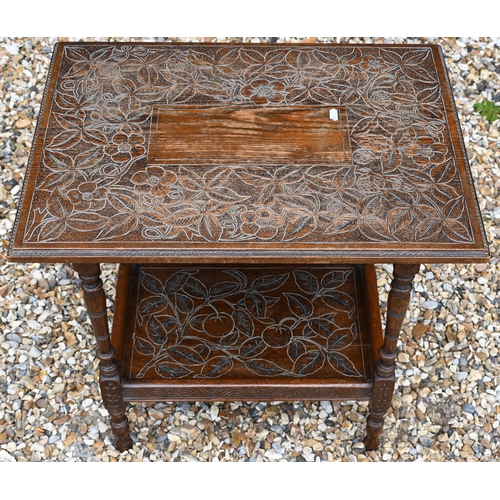 33 - A rectangular oak two-tier side table with floral and foliate carved decoration on slender turned su... 