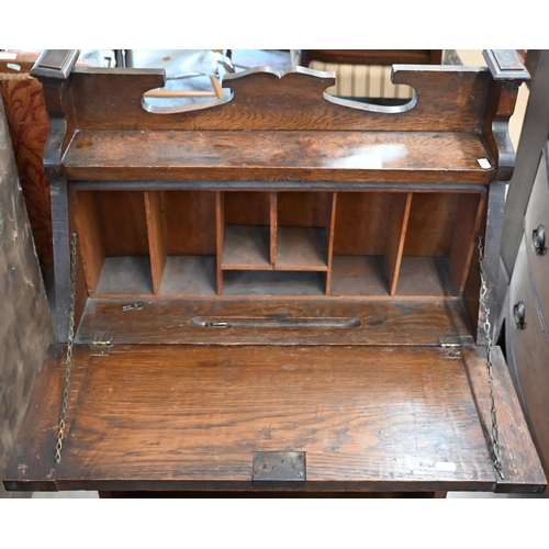 34 - An early 20th century Arts & Crafts oak and metal mounted shallow bureau in the Liberty style, 64 x ... 
