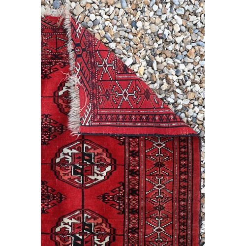 508 - A blue-ground Boteh rug 207cm x 110 cm to/with a red Turkoman rug 146 cm x 112 cm (2)