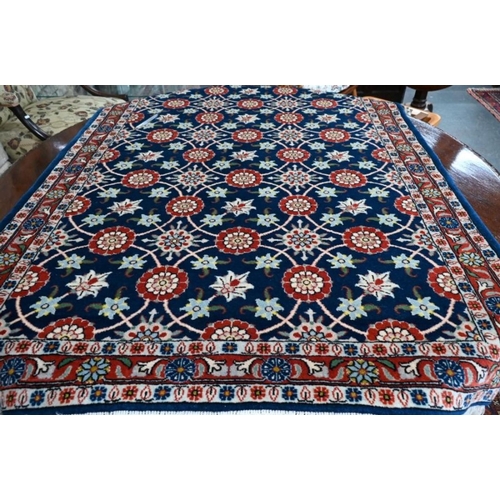 502 - Persian Veremin rug with floral design on a blue ground, 150 x 106 cm