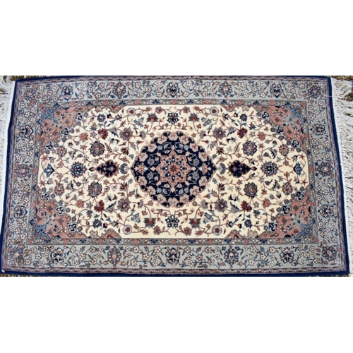 506 - A classic Nian rug, the traditional cream ground with floral design centred by a blue medallion, 154... 