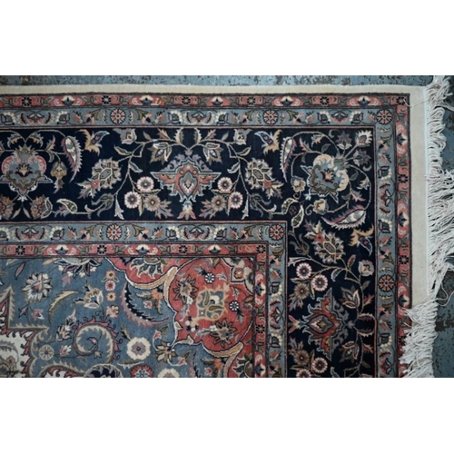 506 - A classic Nian rug, the traditional cream ground with floral design centred by a blue medallion, 154... 