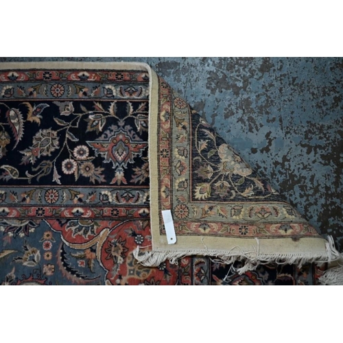 506 - A classic Nian rug, the traditional cream ground with floral design centred by a blue medallion, 154... 