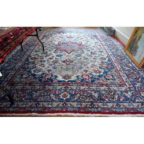 513 - An antique Persian hand-made Isfahan carpet, the ivory field centred by a floral medallion and flowe... 