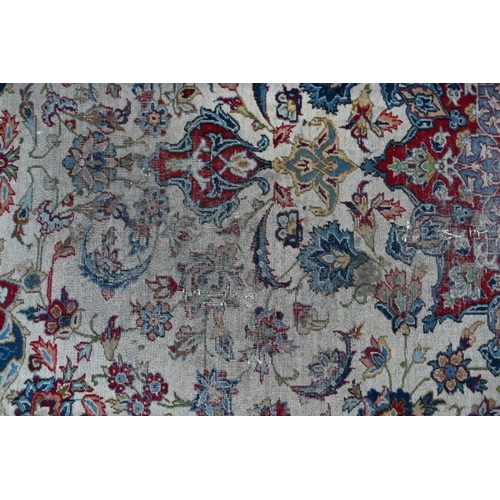 513 - An antique Persian hand-made Isfahan carpet, the ivory field centred by a floral medallion and flowe... 