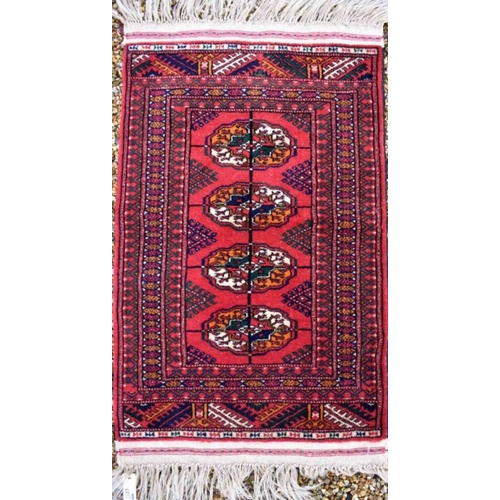 514 - An Afghan Turkman runner, red ground 200 cm x 52 cm to/w a small rug of conforming design, 92 cm x 6... 