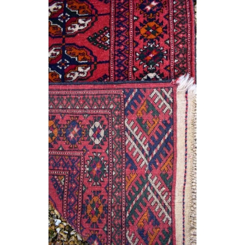 514 - An Afghan Turkman runner, red ground 200 cm x 52 cm to/w a small rug of conforming design, 92 cm x 6... 