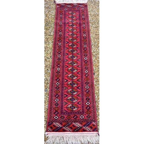 514 - An Afghan Turkman runner, red ground 200 cm x 52 cm to/w a small rug of conforming design, 92 cm x 6... 